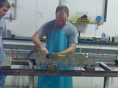 Gerry Vanderbas hand-polishing stone in a fabrication shop, 2006